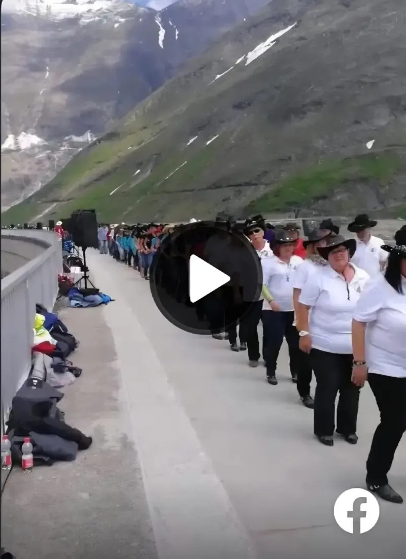 A huge group of people line dancing